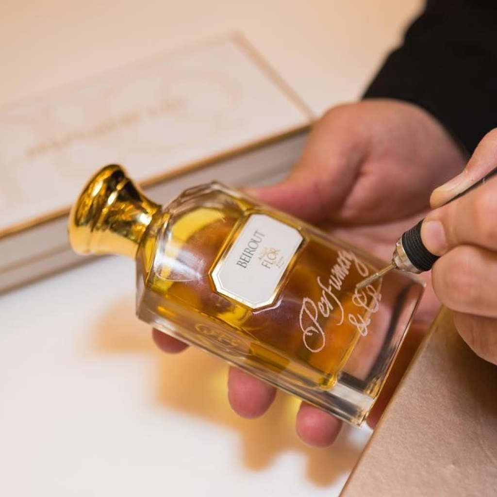 Fragrance bottle being personalized