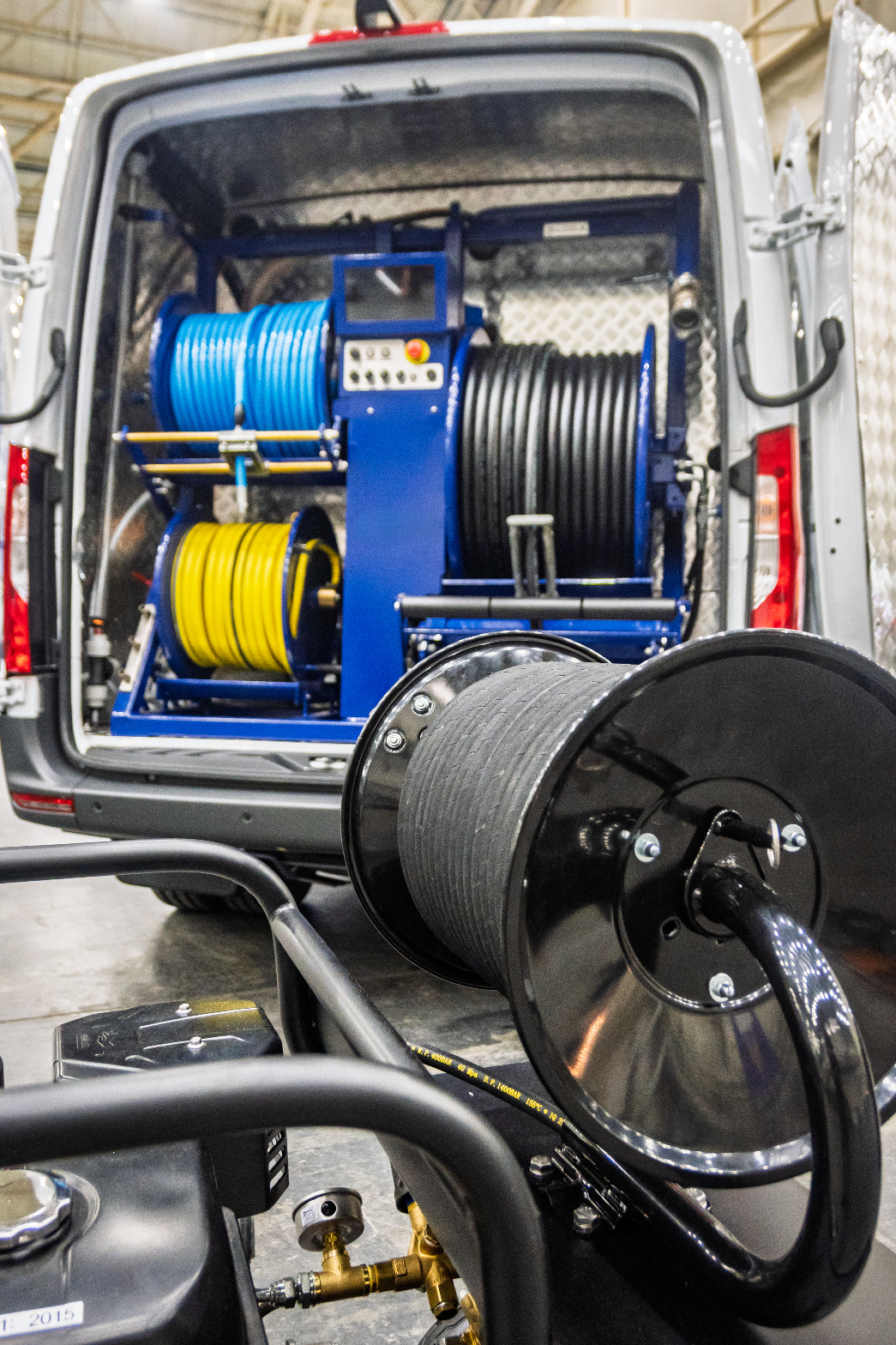 Utility service van equipped with industrial hose reels and field equipment