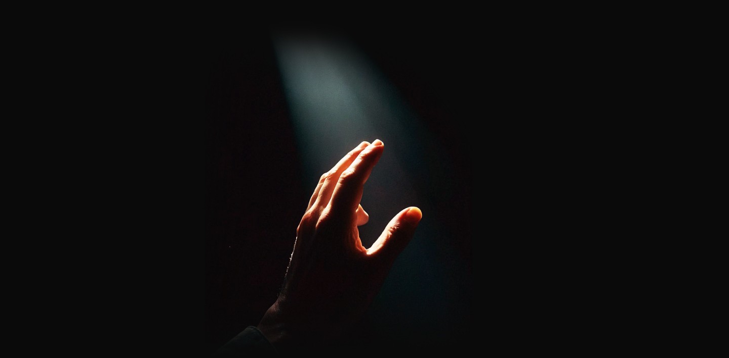 Person hand in dramatic lighting