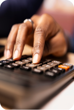 Hand holding a smartphone over printed financial charts