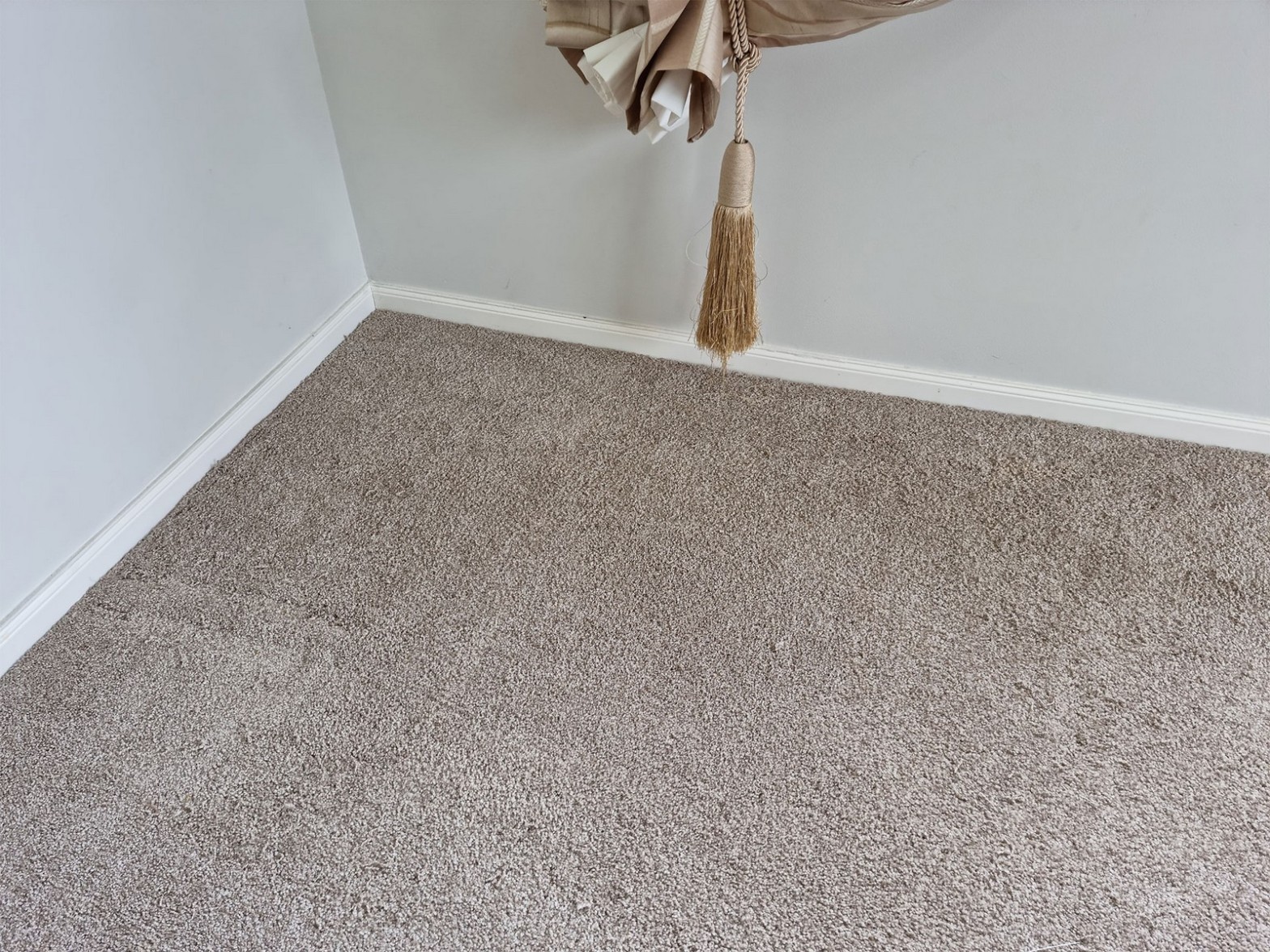 Clean beige carpet in corner of room after repair