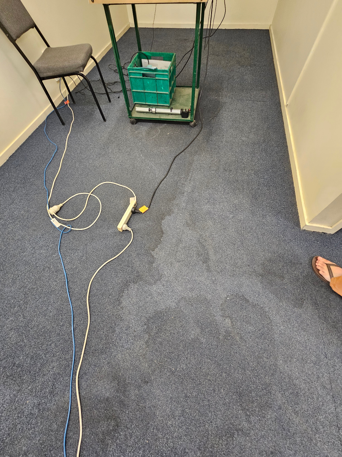 Commercial office carpet cleaned – blue carpet with cleaning equipment and cables on floor