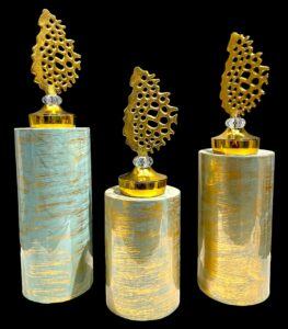 Gold decorative pillar props with ornamental toppers