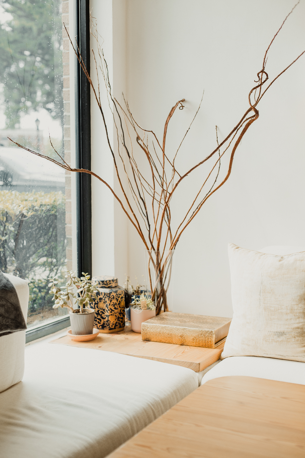 Window seat with branches and ceramics